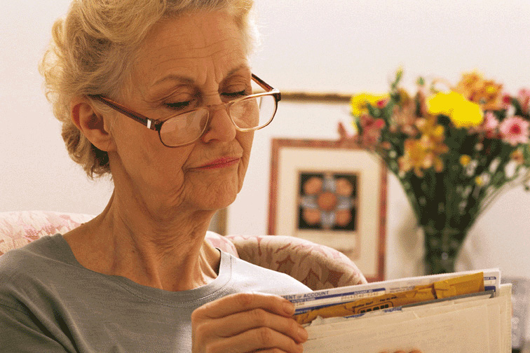 Senior woman going through paperwork